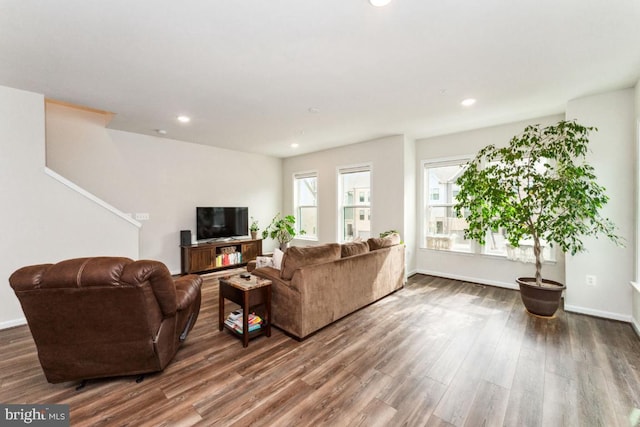 living room featuring baseboards, wood finished floors, and recessed lighting