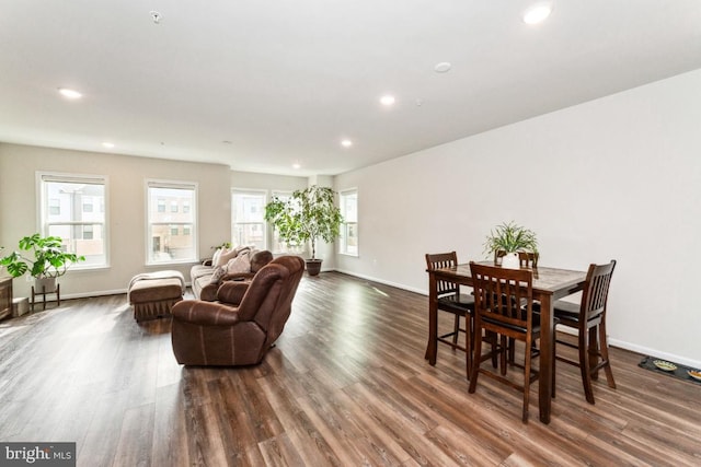 dining space with baseboards, dark wood-style flooring, and recessed lighting