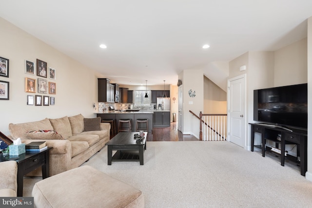 carpeted living room featuring recessed lighting and baseboards