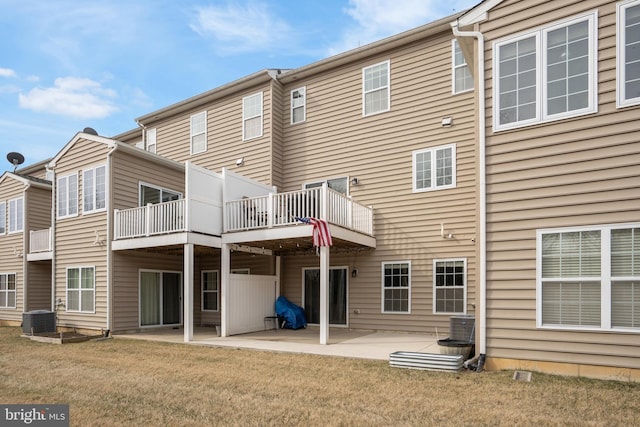 rear view of house with a yard, central AC unit, and a patio area