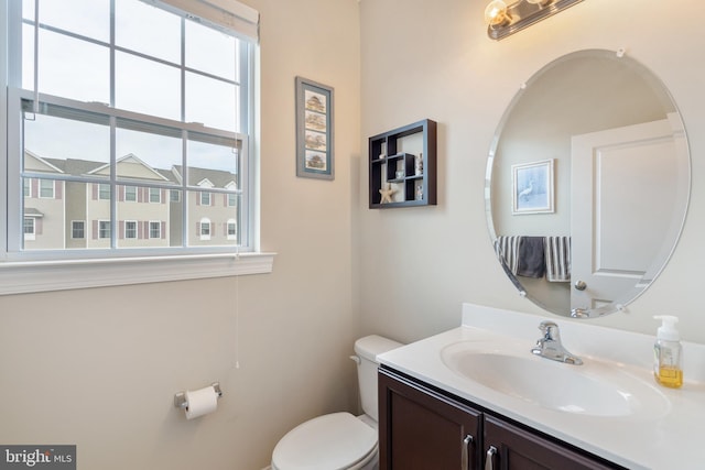 bathroom featuring toilet and vanity