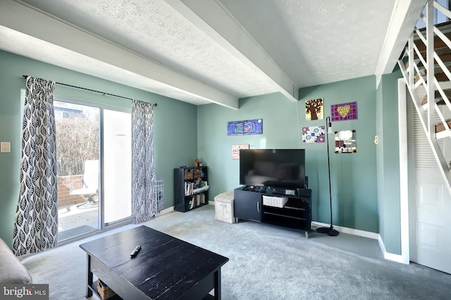 carpeted living room featuring a textured ceiling, beamed ceiling, and baseboards