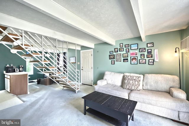 living room featuring carpet, beam ceiling, stairway, and a textured ceiling