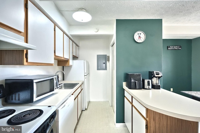 kitchen with light countertops, stove, white dishwasher, a sink, and electric panel