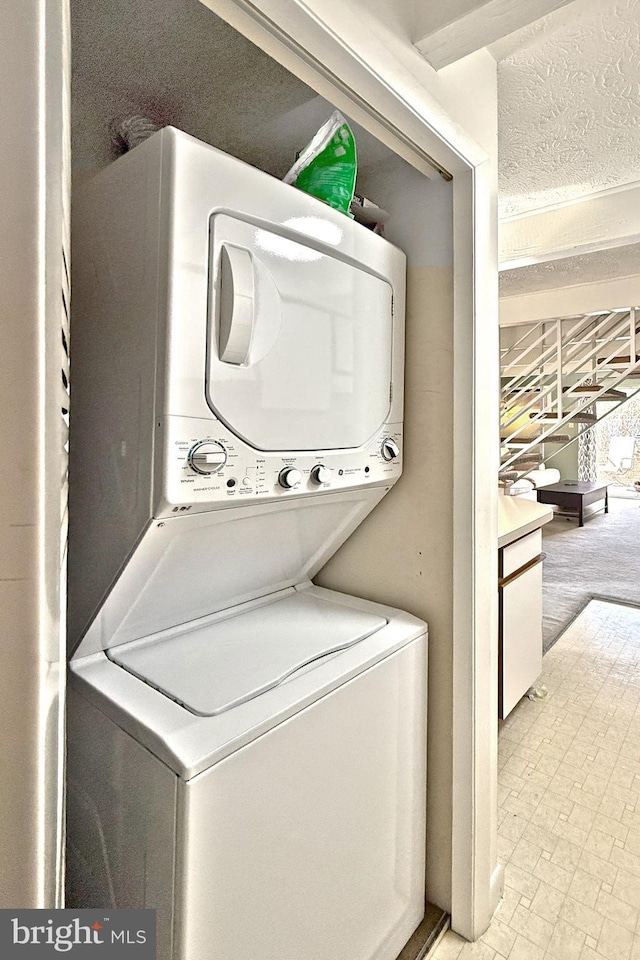 laundry area with laundry area and stacked washing maching and dryer