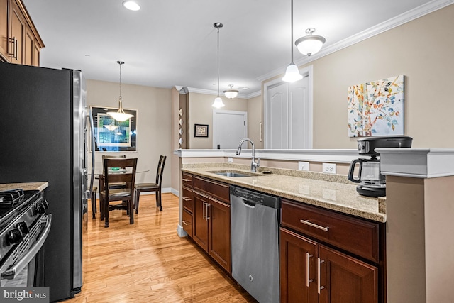 kitchen featuring black range with gas cooktop, a sink, stainless steel dishwasher, light wood finished floors, and crown molding