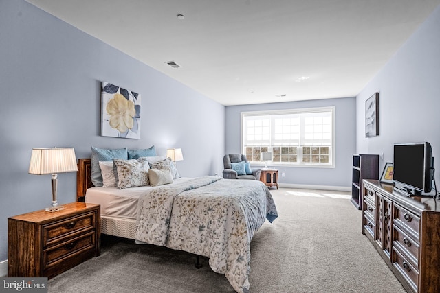 carpeted bedroom featuring visible vents and baseboards