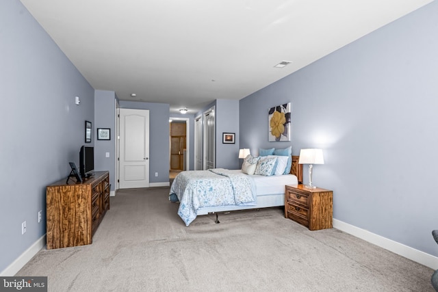 bedroom featuring carpet, visible vents, baseboards, and ensuite bathroom