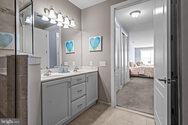 ensuite bathroom featuring double vanity, a sink, ensuite bath, tiled shower, and tile patterned floors