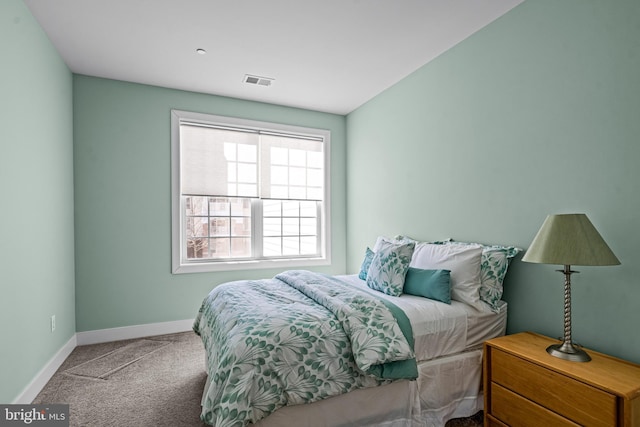 carpeted bedroom with visible vents and baseboards