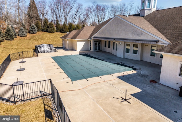 view of swimming pool with a patio, fence, and a fenced in pool