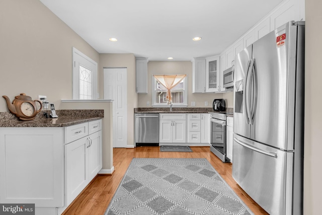 603 N York Rd, Sterling, VA 20164 - kitchen with appliances with stainless steel finishes, light wood-type flooring, white cabinetry, a sink, and recessed lighting