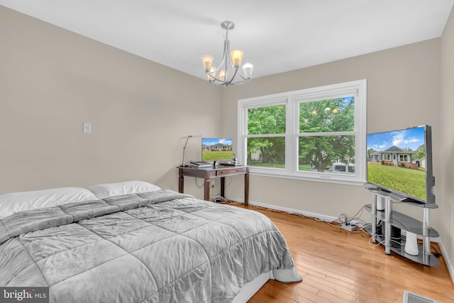 603 N York Rd, Sterling, VA 20164 - bedroom with a chandelier, light wood-style flooring, and baseboards