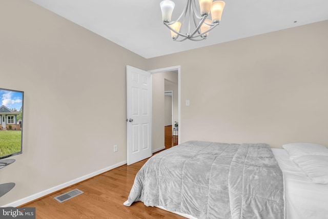 603 N York Rd, Sterling, VA 20164 - bedroom with a chandelier, baseboards, and wood finished floors