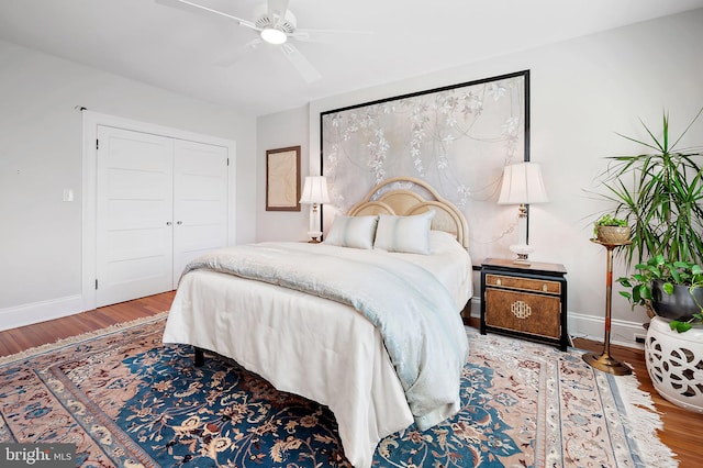 bedroom featuring a closet, baseboards, and wood finished floors