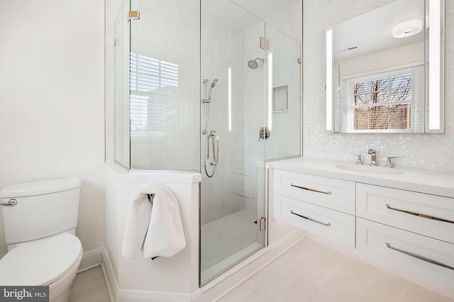 full bath featuring decorative backsplash, a shower stall, toilet, and vanity