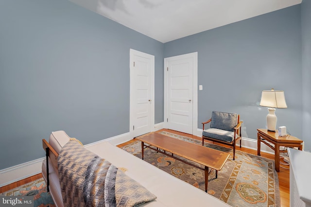 living area featuring wood finished floors and baseboards