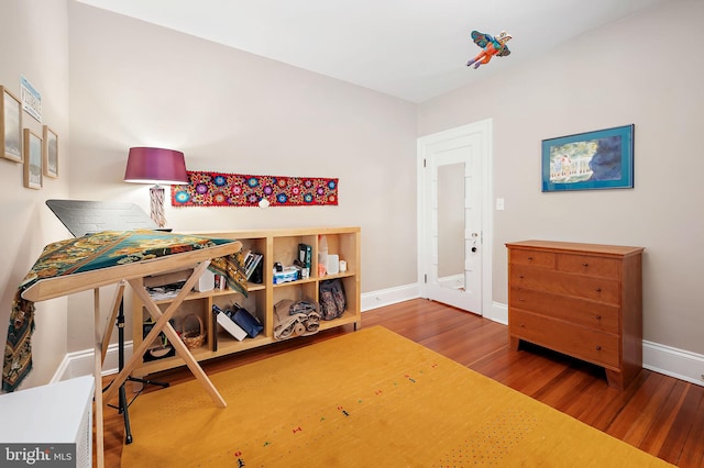 interior space with wood finished floors and baseboards