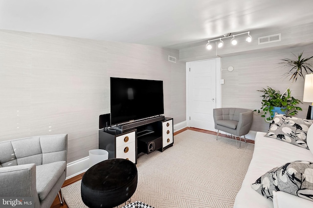 living area with visible vents and baseboards