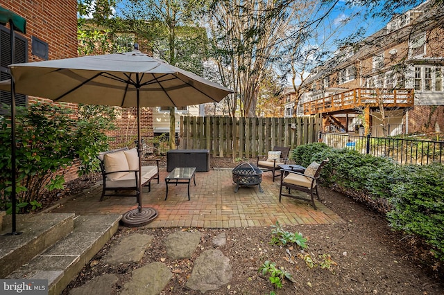 view of patio / terrace with fence and a fire pit