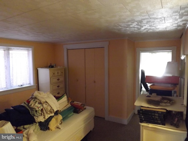 bedroom with a closet and baseboards