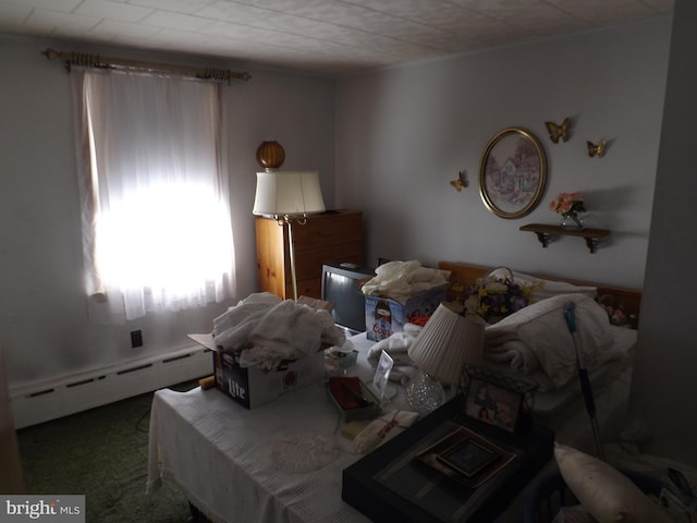 bedroom featuring a baseboard heating unit and carpet