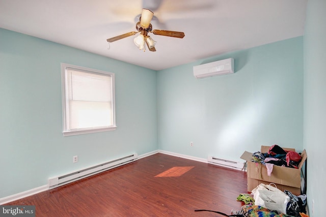 unfurnished room with baseboards, a baseboard heating unit, wood finished floors, and a wall mounted AC