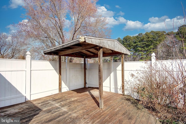 wooden terrace featuring fence