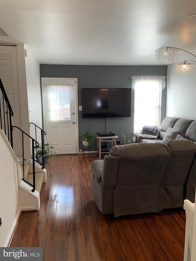 living room with stairway, baseboards, and hardwood / wood-style floors