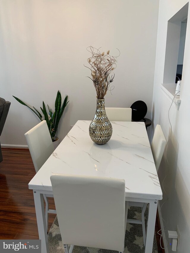 dining room featuring dark wood-style flooring