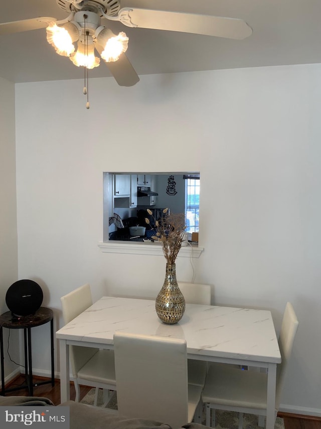 dining area with baseboards and ceiling fan