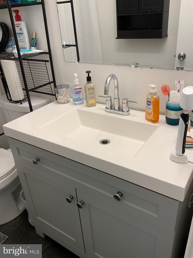 bathroom featuring toilet and vanity