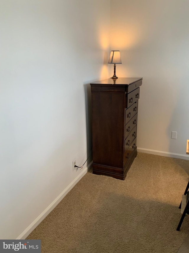 unfurnished bedroom featuring baseboards and carpet