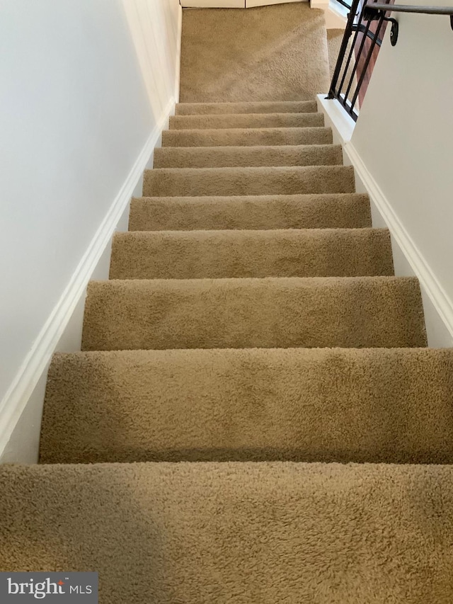 stairway featuring baseboards