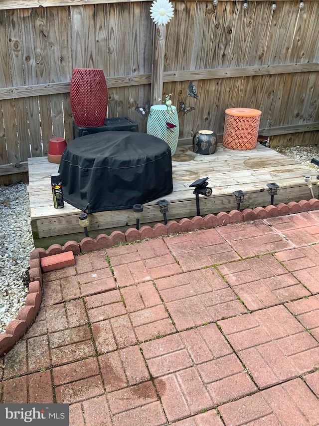 view of patio / terrace featuring grilling area and fence