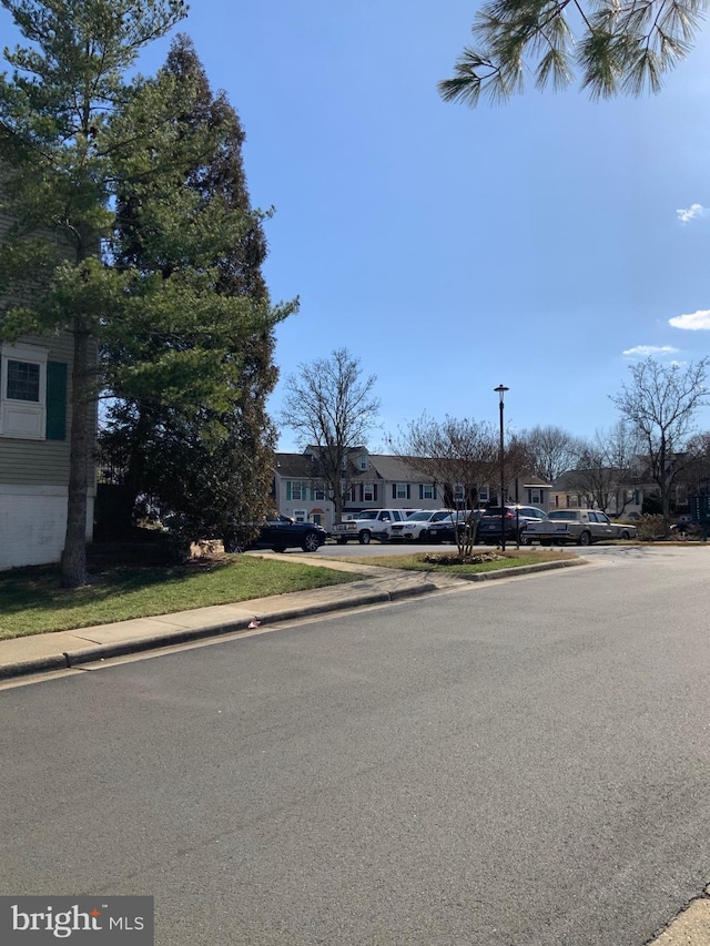 view of street featuring sidewalks, a residential view, and curbs