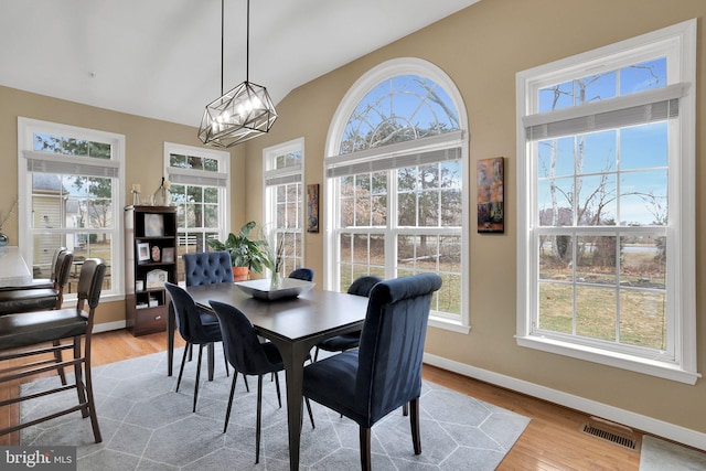 13110 Ogles Hope Dr, Bowie, MD 20720 - dining room featuring a chandelier, plenty of natural light, light wood-style flooring, and baseboards