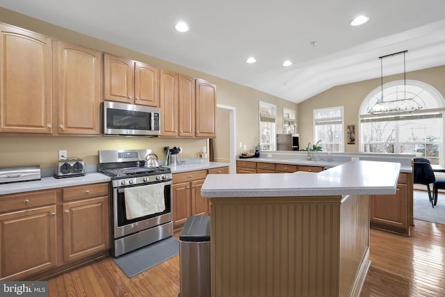 13110 Ogles Hope Dr, Bowie, MD 20720 - kitchen with stainless steel appliances, a kitchen island, light countertops, and decorative light fixtures
