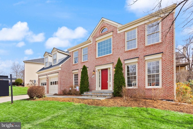 view of front facade with brick siding, an attached garage, and a front yard