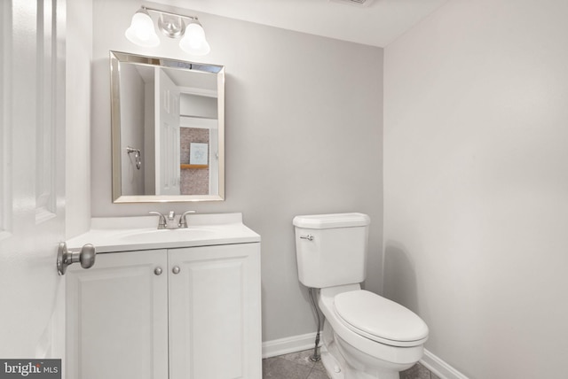 half bath featuring visible vents, toilet, vanity, baseboards, and tile patterned floors