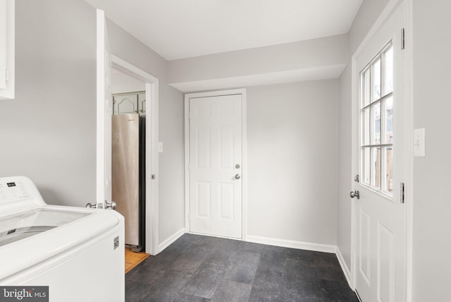 laundry area featuring washer / dryer, baseboards, water heater, and laundry area