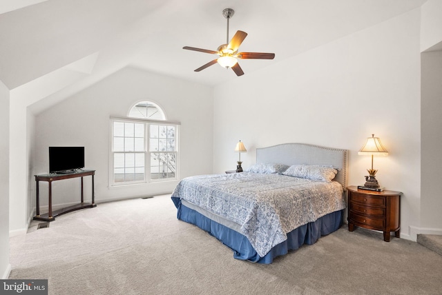 carpeted bedroom featuring lofted ceiling, visible vents, a ceiling fan, and baseboards