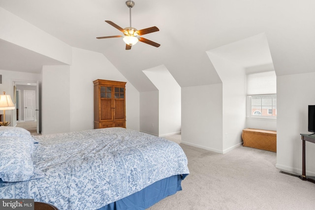 carpeted bedroom featuring a ceiling fan, lofted ceiling, and baseboards