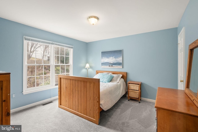 bedroom with carpet floors, visible vents, and baseboards