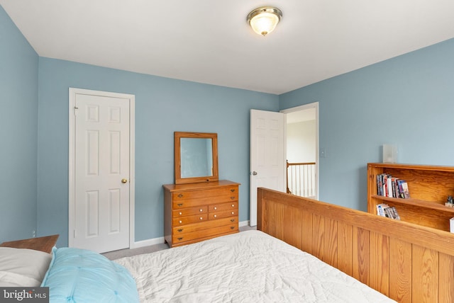 carpeted bedroom featuring baseboards