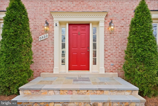 property entrance with brick siding