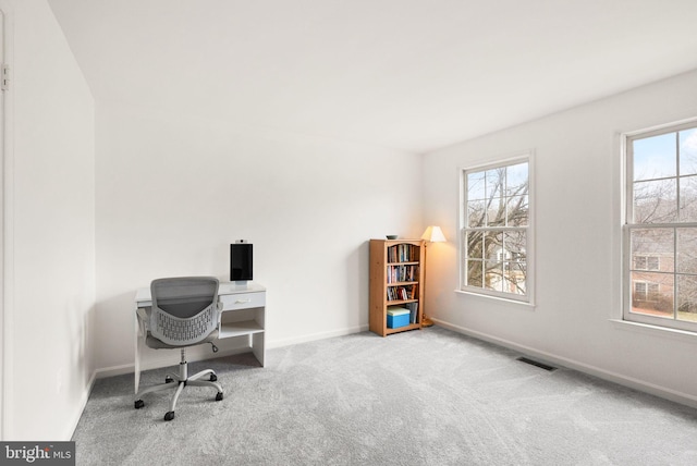 office featuring baseboards, visible vents, and carpet flooring