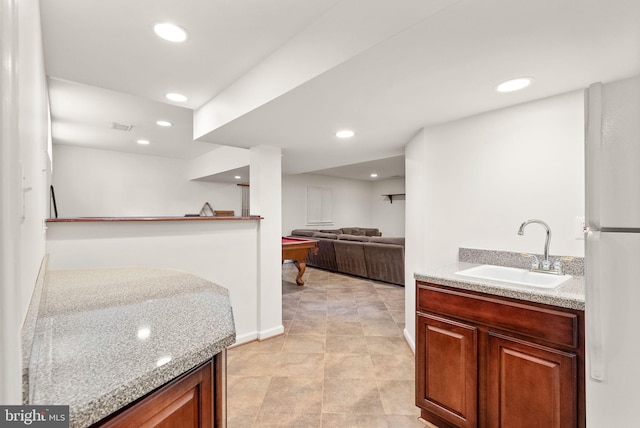 kitchen with recessed lighting, light countertops, a sink, and visible vents