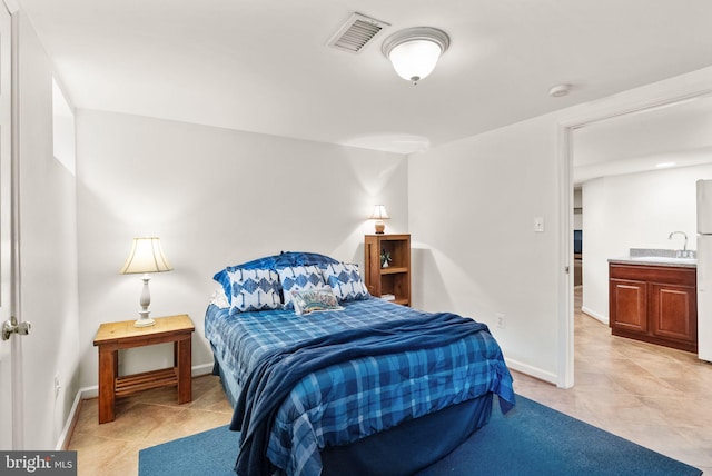 bedroom with visible vents, a sink, baseboards, and light tile patterned floors