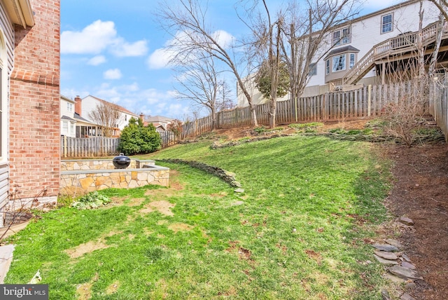 view of yard featuring a fenced backyard and a residential view